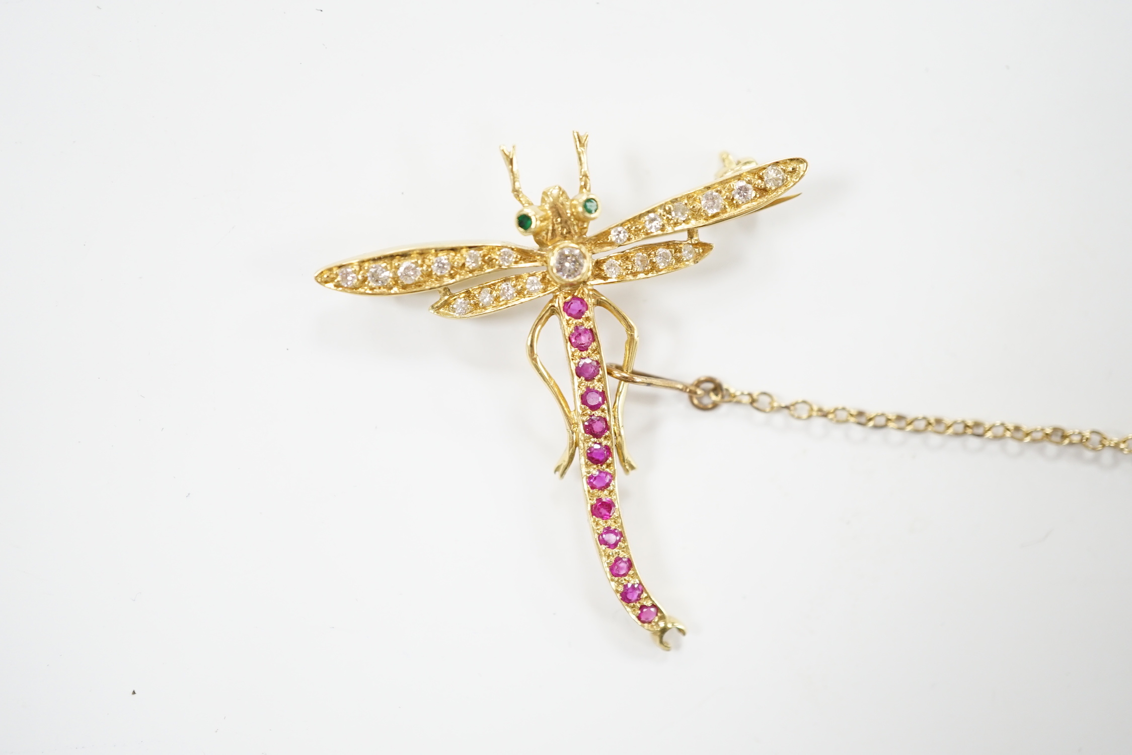 A modern 18ct gold, ruby, emerald and diamond cluster set dragonfly brooch, 40mm, gross weight 4.8 grams.